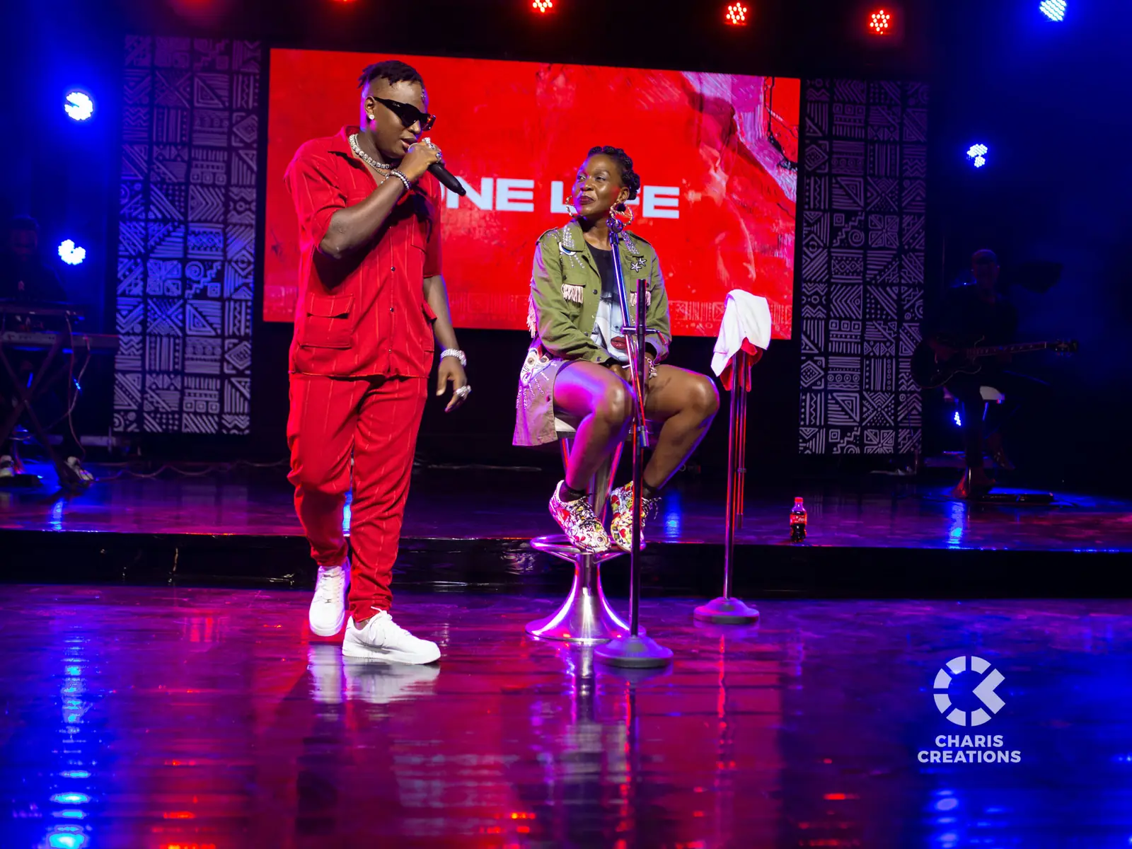 Performers on a lit stage at a live event